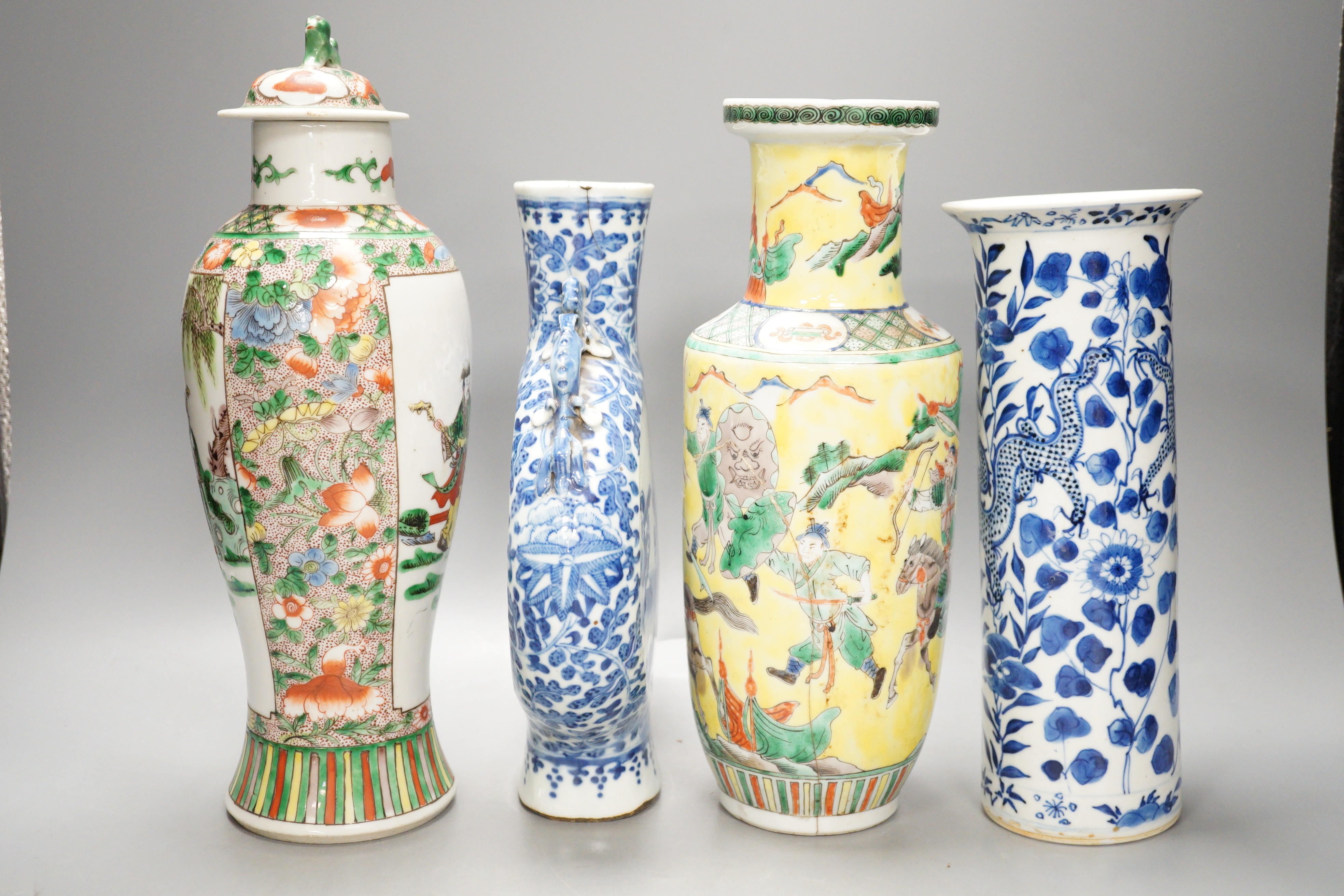 A Chinese famille verte vase and cover, a yellow ground ‘soldiers’ vase, a blue and white moonflask and a similar’dragon’ sleeve vase, all late 19th/early 20th century, Tallest 33cm